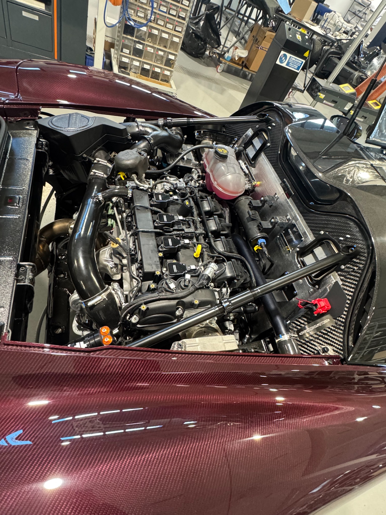 Open engine bay of a Dallara Stradale showing the transverse turbocharged inline-four